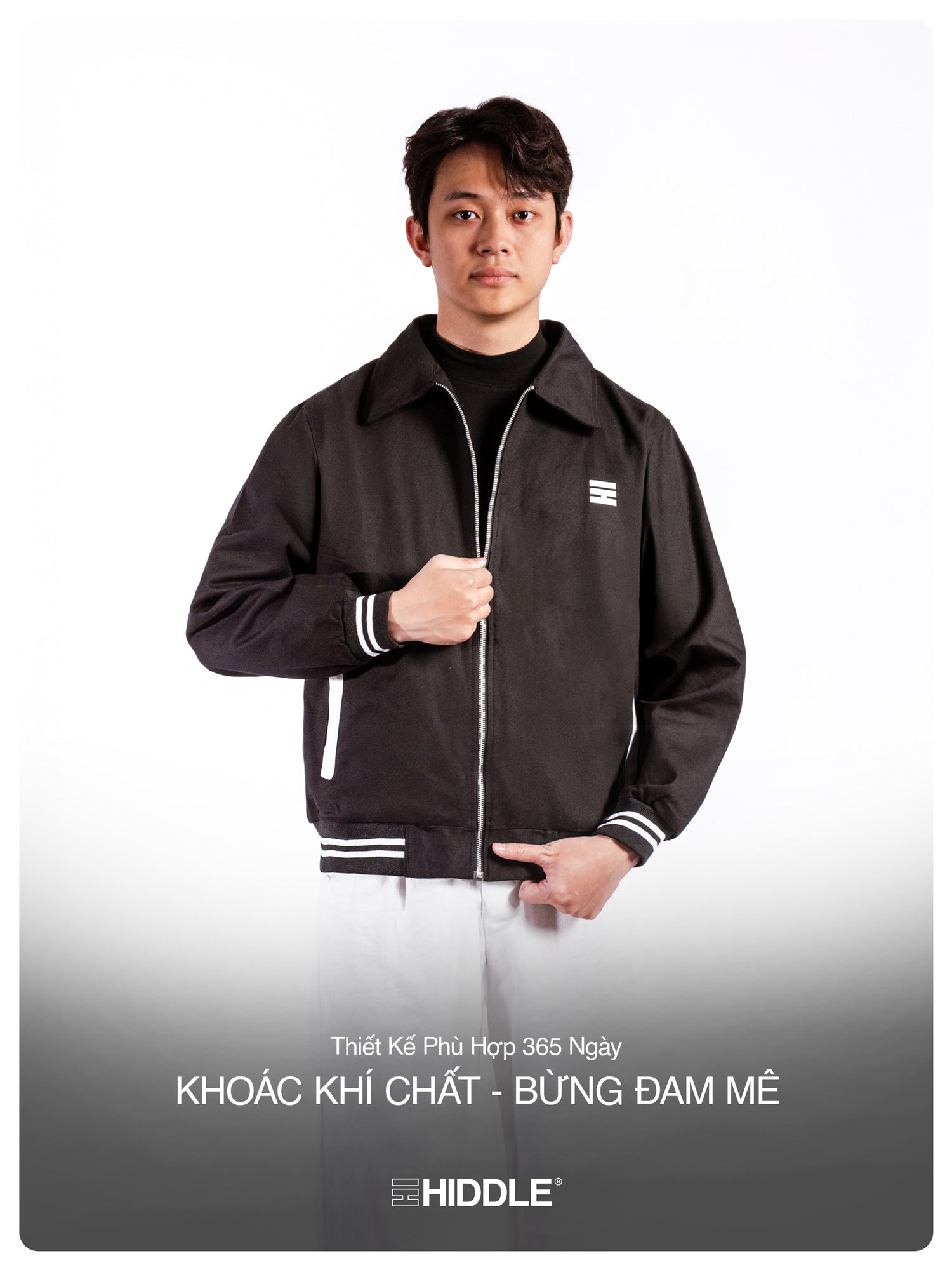 Man wearing a black jacket with a brand logo on a white background