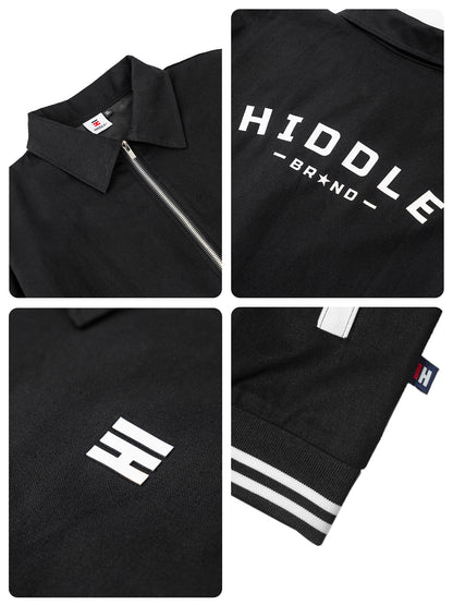 Black polo shirt with visible branding details on a white background