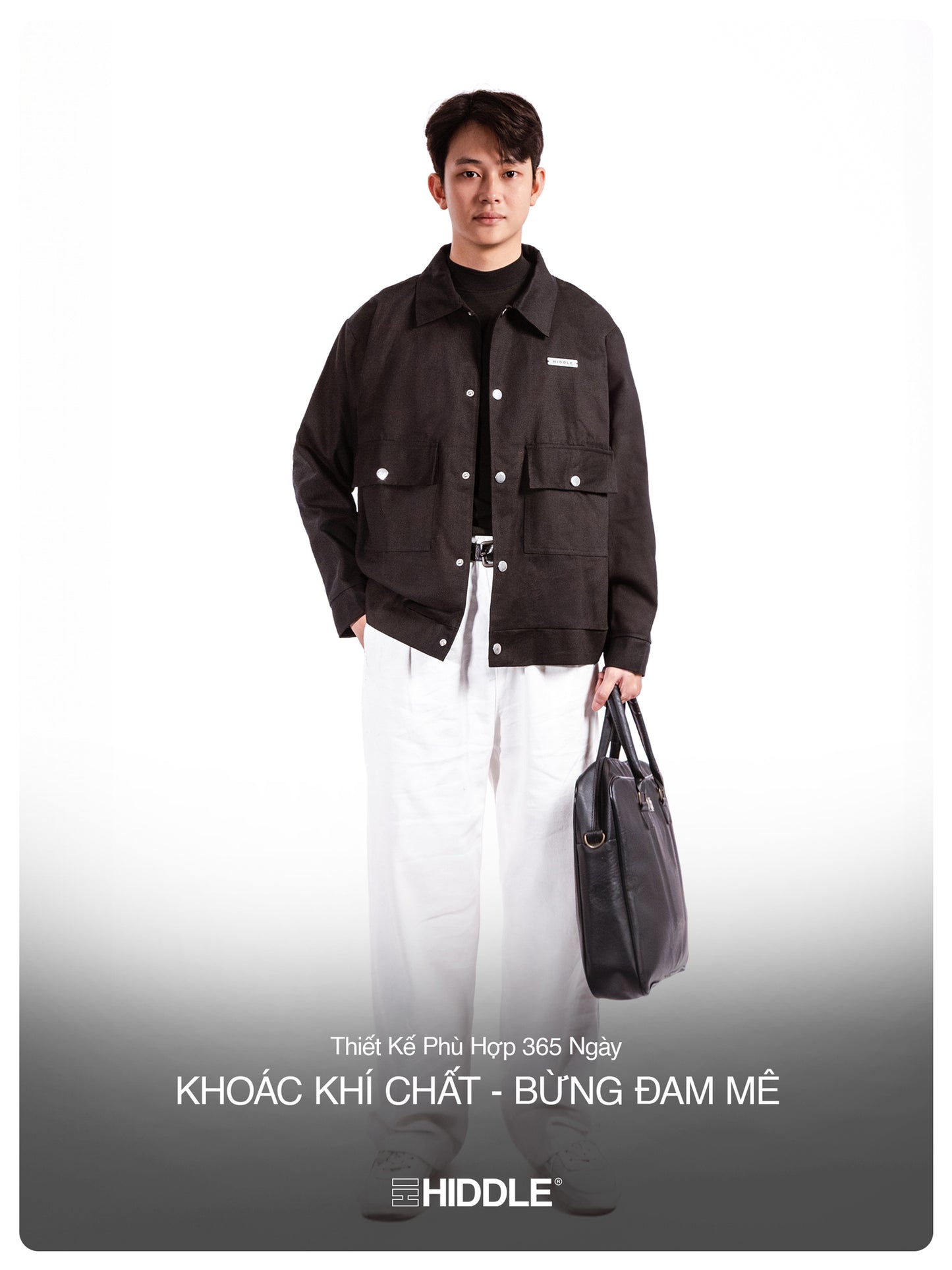 Man wearing a black jacket holding a bag on a white background with Hiddle branding.