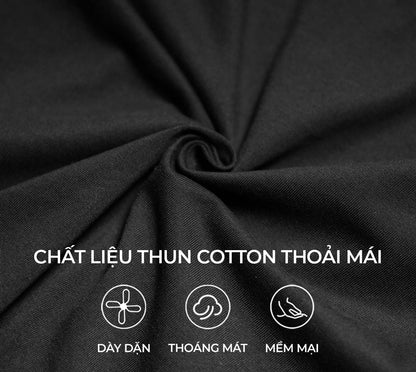 Close-up of black fabric with text indicating cotton material properties.