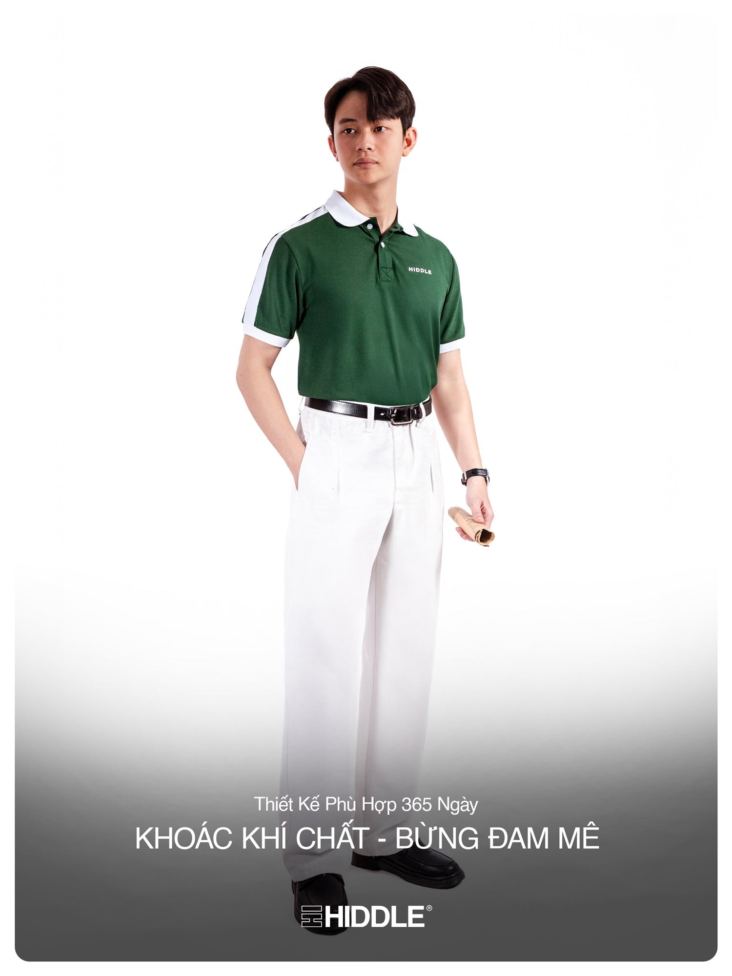 Man wearing a green polo shirt and white pants with a visible brand logo on a white background.