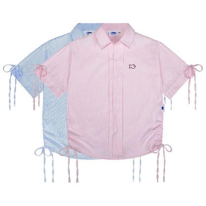 Pink and blue striped shirt with fish embroidery on a white background