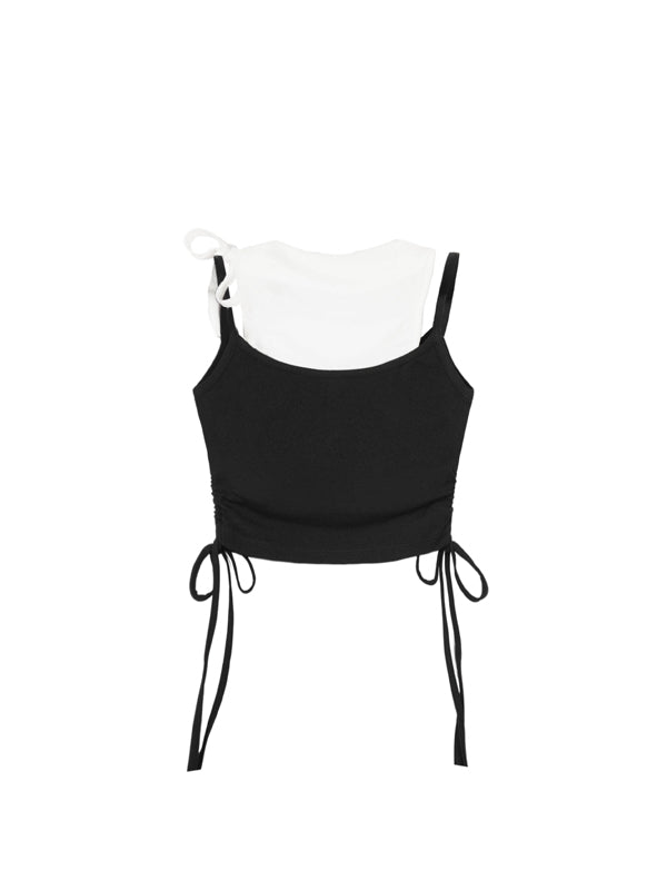 Black crop top with thin straps on a white mannequin against a white background