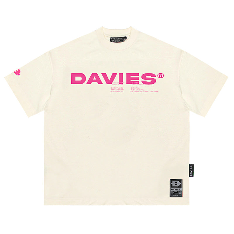 Beige t-shirt with pink 'DAVIES' logo on a white background