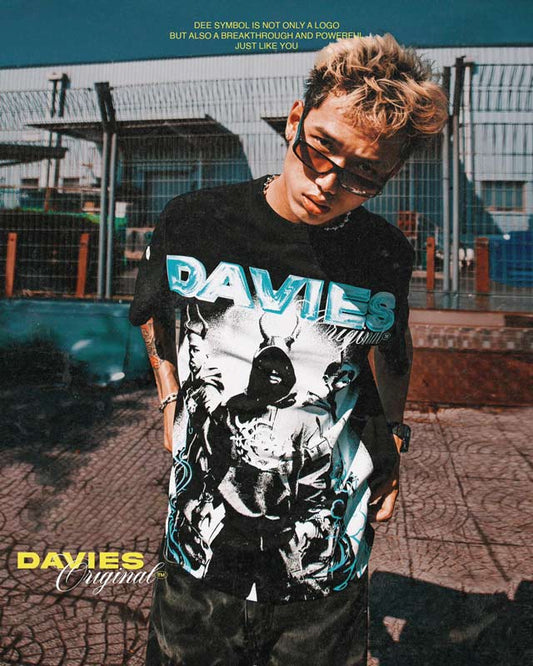 Person wearing a black t-shirt with 'DAVIES' branding outdoors.