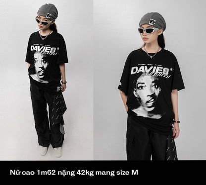 Person wearing a black t-shirt with a graphic design on a white background
