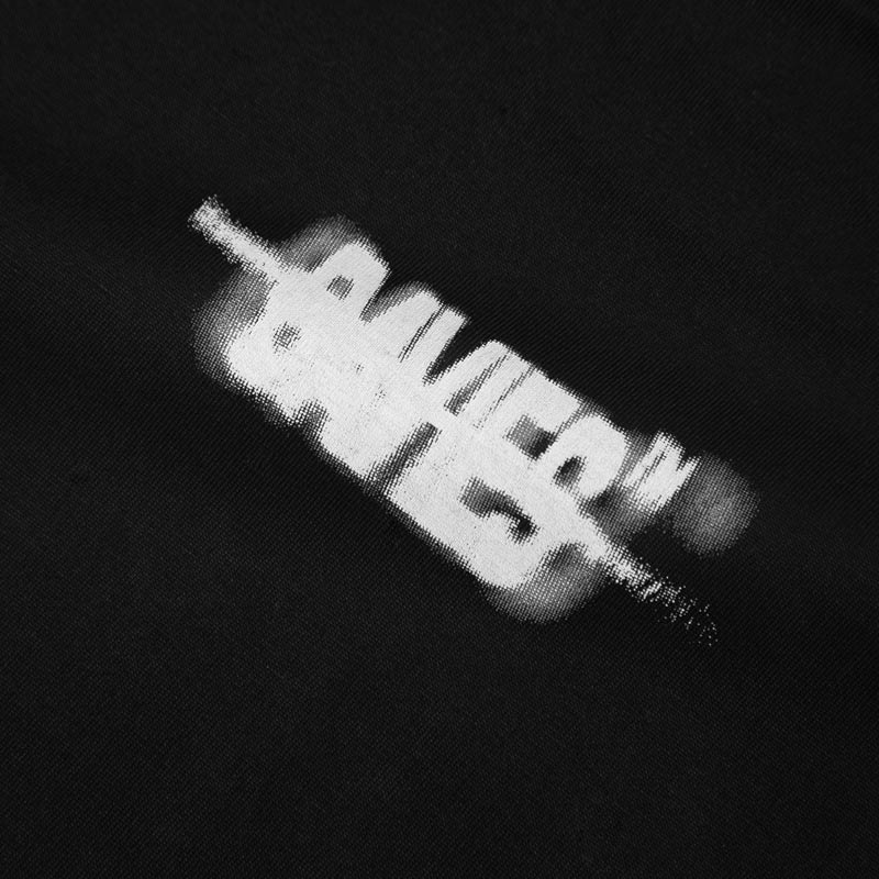 Black and white image of a bottle with text on a black background