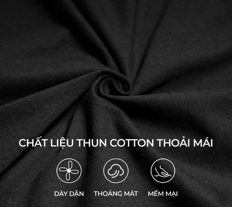 Close-up of black fabric with text indicating cotton material properties.