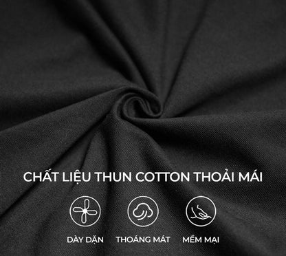 Close-up of black fabric with text indicating cotton material properties.