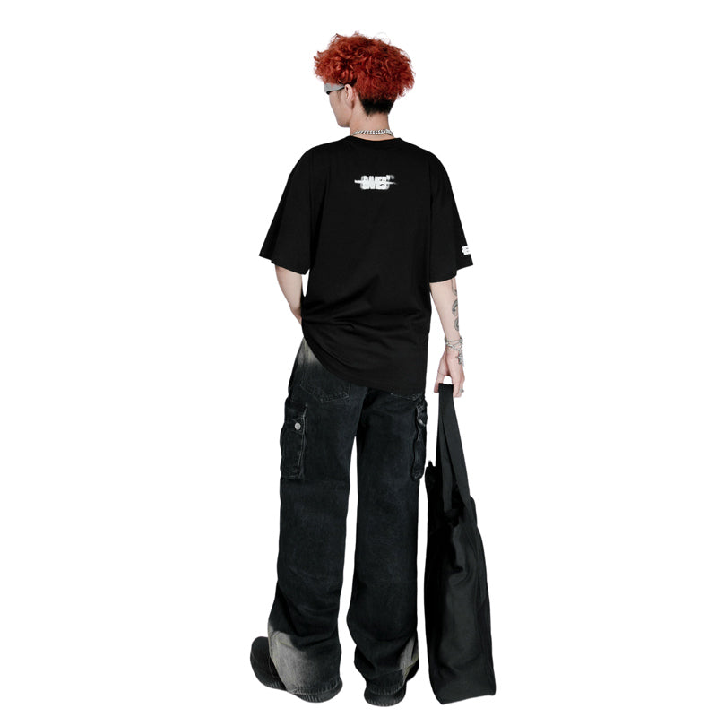 Person wearing a black t-shirt and pants holding a black bag on a white background