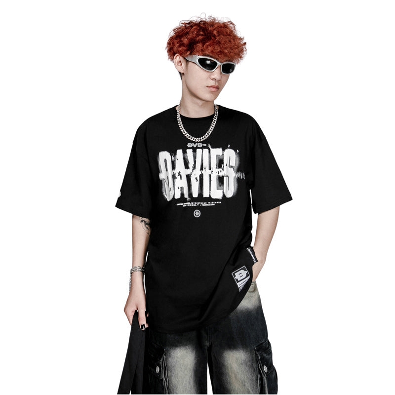Person wearing a black t-shirt with white text, sunglasses, and a chain necklace on a white background