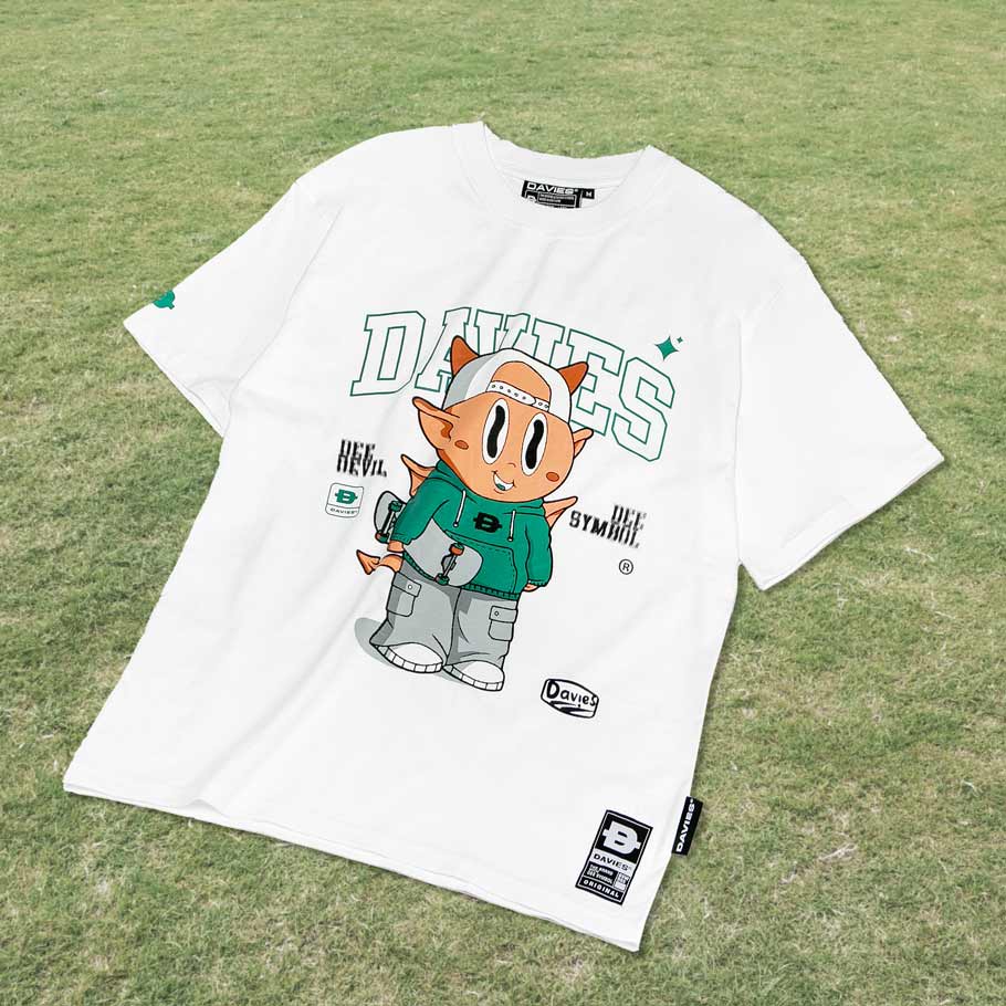 White t-shirt with cartoon character and text on a grass background