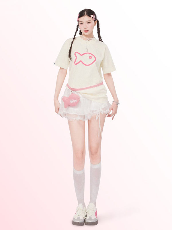 Person wearing a light-colored outfit with a pink fish design on a white background