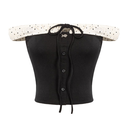 Black ribbed crop top with polka dot trim on a white background