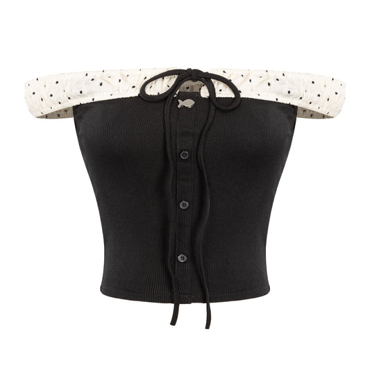 Black ribbed crop top with polka dot trim on a white background