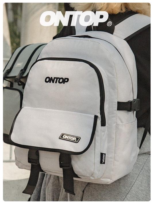 White backpack with 'ONTOP' branding worn by a person.