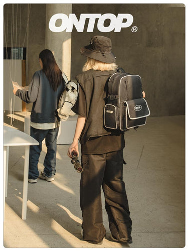 Person wearing a backpack with 'ONTOP' branding in an urban setting.