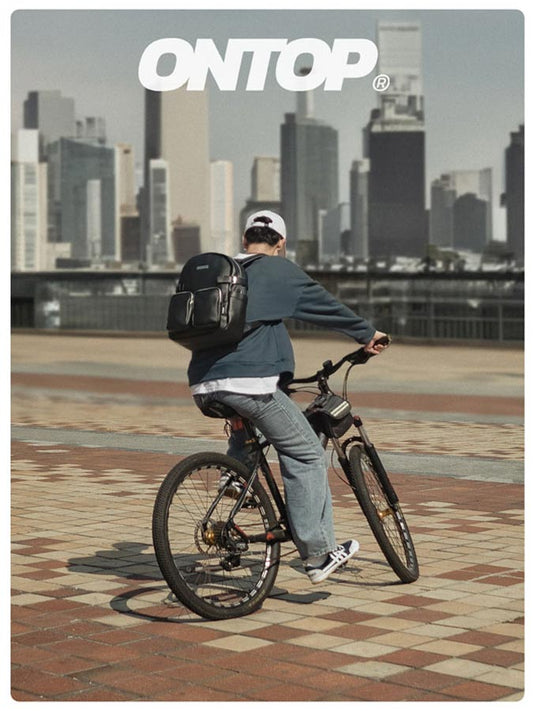 Person riding a bicycle with a city skyline in the background, featuring the brand 'ONTOP'.