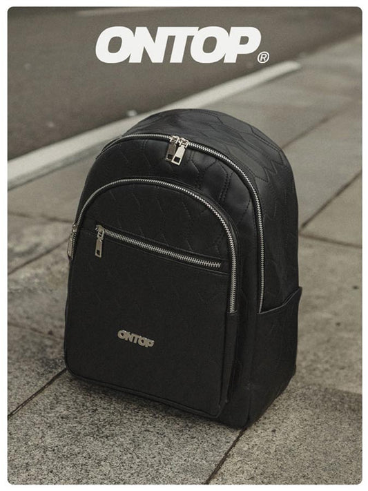 Black backpack with 'ONTOP' branding on a pavement background
