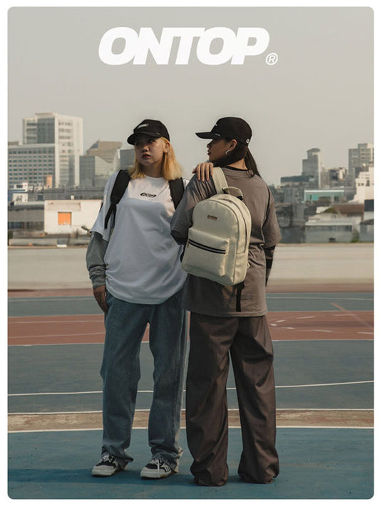 Two people standing on a rooftop with 'ONTOP' branding.