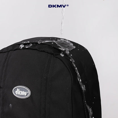 Black backpack with water splashing on it, featuring the DKMV logo.