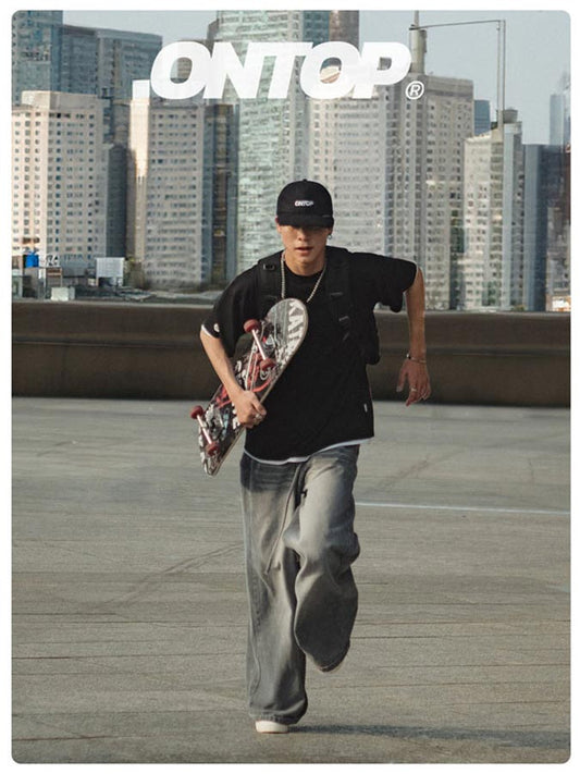 Person holding a skateboard with a cityscape background and 'ONTOP' branding.