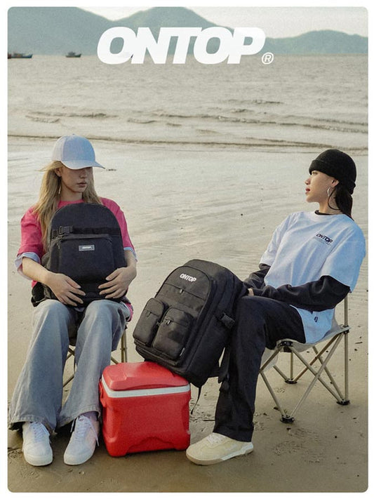 Two people sitting on chairs with backpacks and a cooler, featuring the 'ONTOP' brand.