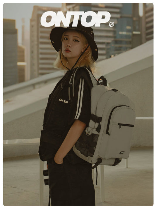 Person wearing a black outfit with a white backpack on a rooftop with 'ONTOP' branding.