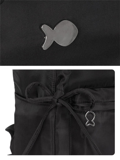 Black jacket with fish-shaped metal emblem on a dark background