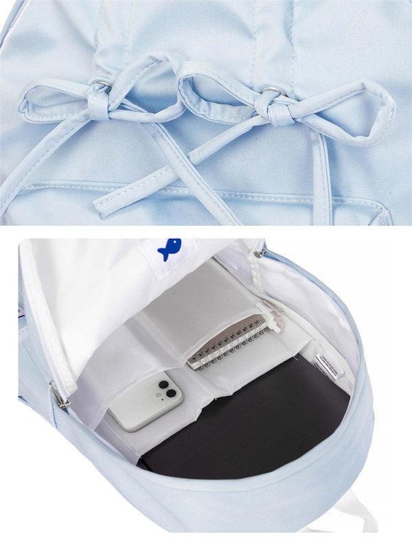 Light blue backpack with a bow detail, showing interior compartments.