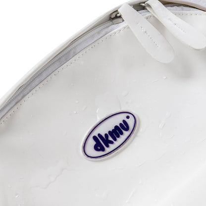 Close-up of a white shoe with a blue and white logo on a white background