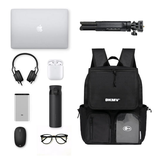 Black backpack with various items including a laptop, headphones, and a water bottle on a white background.
