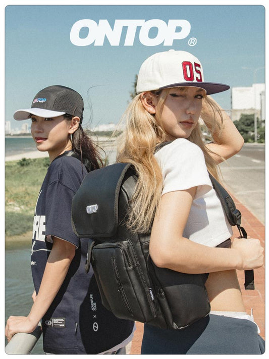 Two people wearing black backpacks with 'ONTOP' branding, standing outdoors.