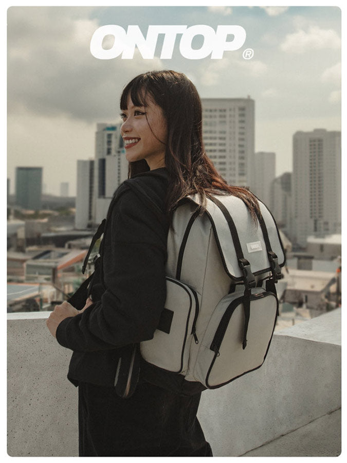 Person wearing a backpack with a cityscape in the background, featuring the brand 'ONTOP'.