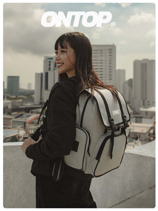 Person wearing a backpack with a cityscape in the background, featuring the brand 'ONTOP'.