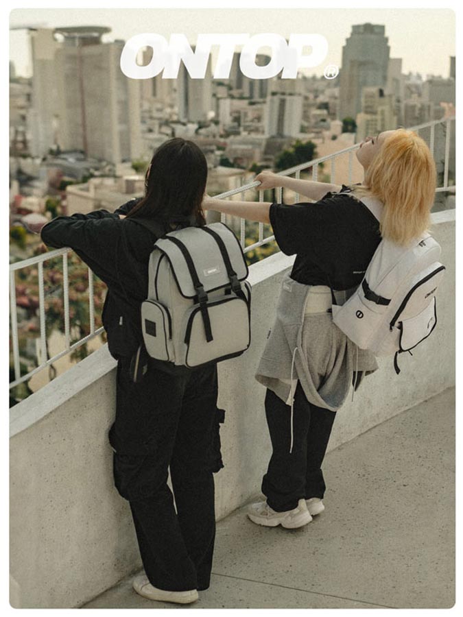 Two people standing on a rooftop overlooking a cityscape with 'ONTOP' branding.