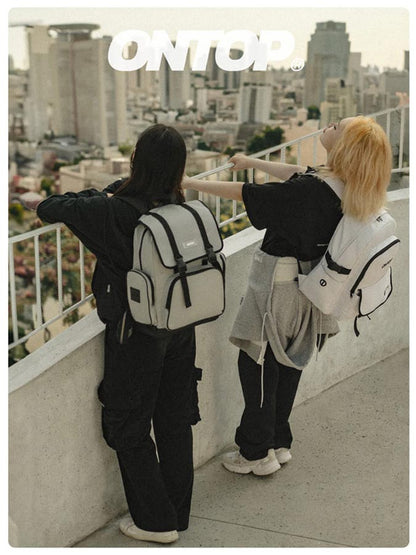 Two people standing on a rooftop overlooking a cityscape with 'ONTOP' branding.