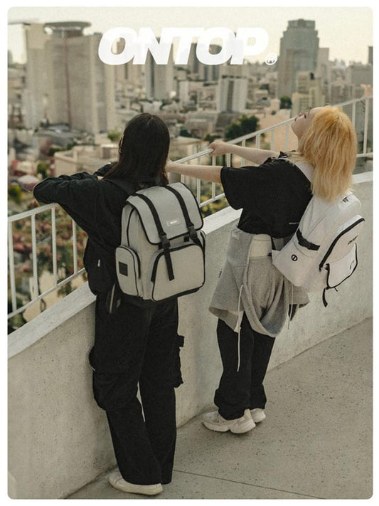 Two people standing on a rooftop overlooking a cityscape with 'ONTOP' branding.