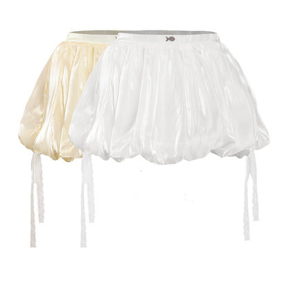 Two sheer petticoats, one white and one beige, on a white background.