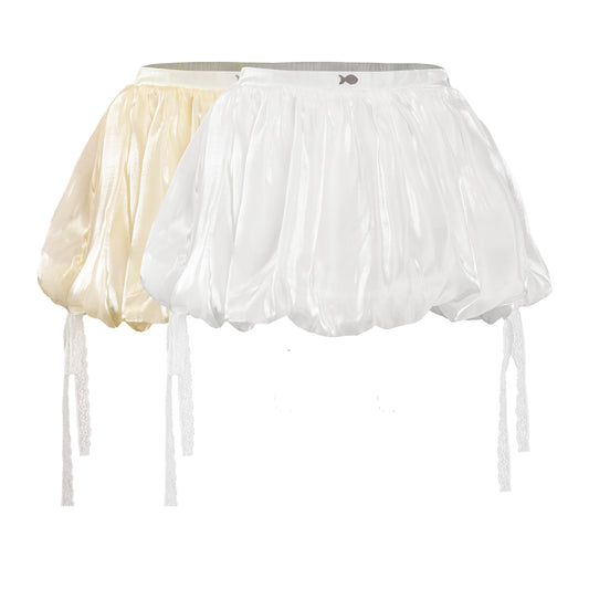 Two sheer petticoats, one white and one beige, on a white background.