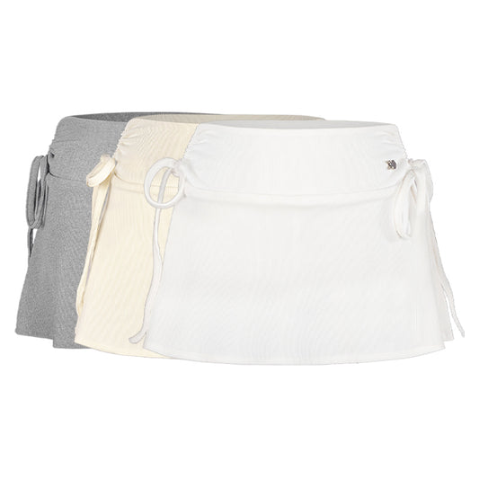 Three aprons in gray, beige, and white on a white background