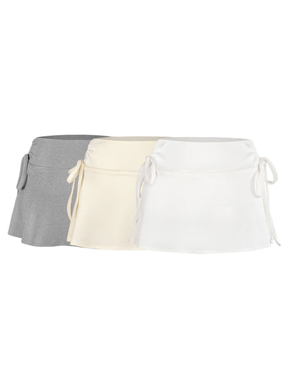 Three waist belts in gray, beige, and white on a white background