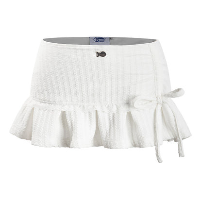 White skirt with ruffled bottom and tie detail on a white background