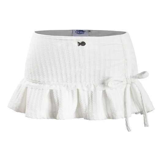 White skirt with ruffled bottom and tie detail on a white background