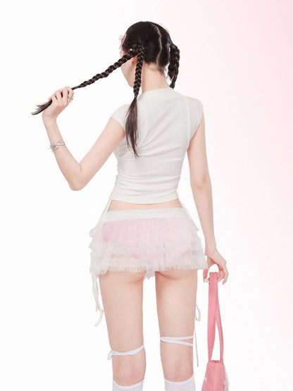 Woman wearing a white top and pink skirt with a pink bag on a white background