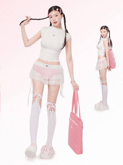 Person wearing a white top, pink skirt, and white knee-high socks with a pink bag on a white background