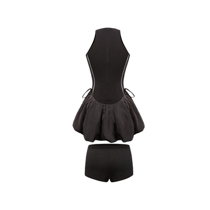 Black swimsuit with a peplum top and shorts on a white background