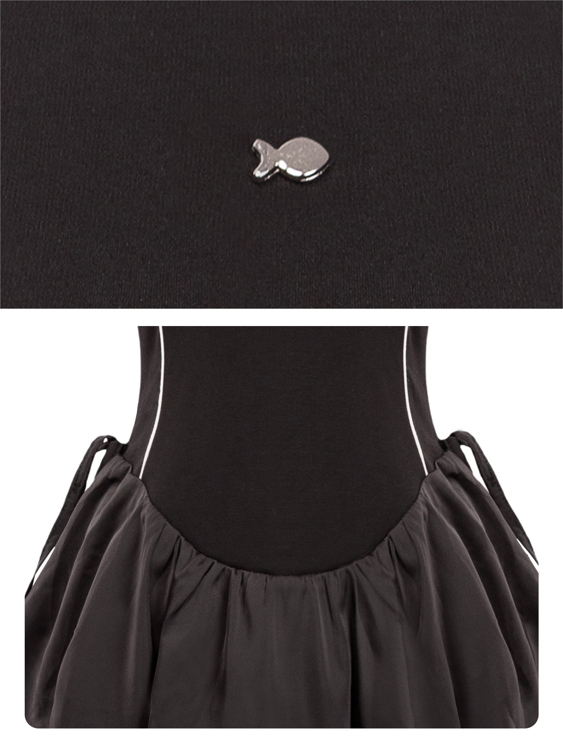 Black dress with a fish-shaped brooch on a white background