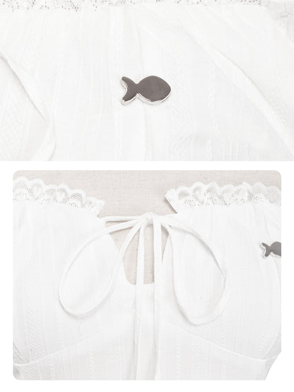 White baby outfit with fish design on a white background
