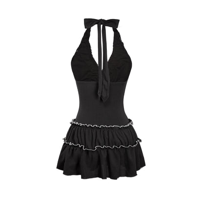 Black halter top with ruffled skirt on a white background